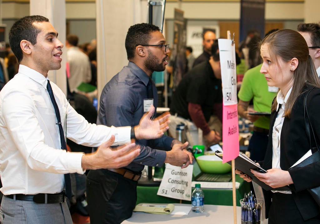 A Mason alum meets with an employer at a Mason Career Fair