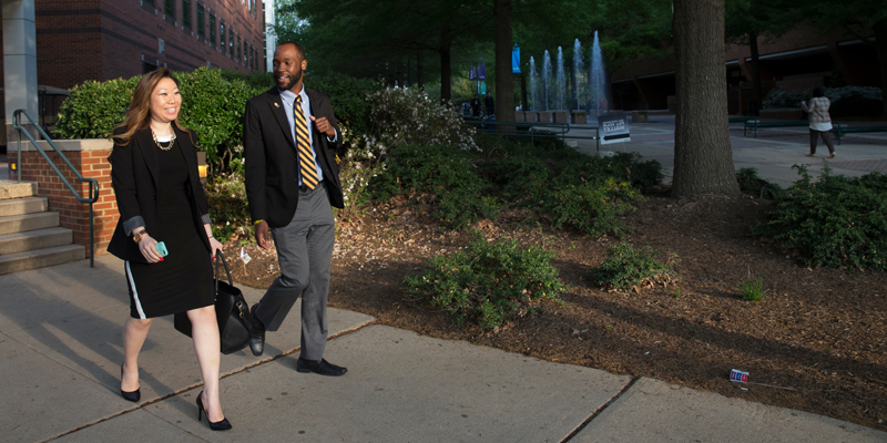 Two students walk together on campus