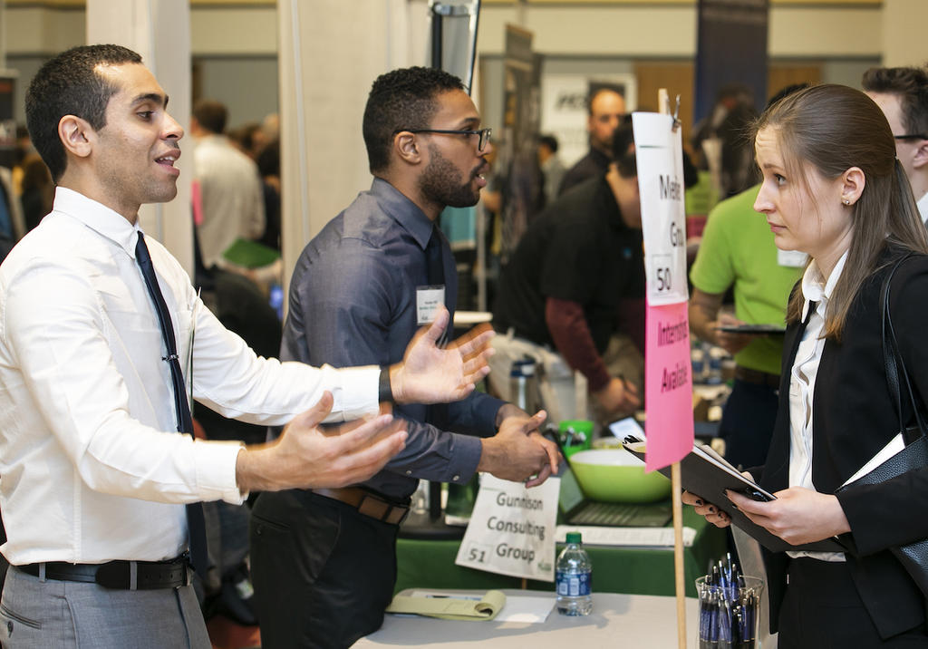 A Mason alum meets with an employer at a Mason Career Fair