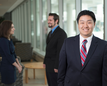 Students dressed in business suits mingle at George Mason University